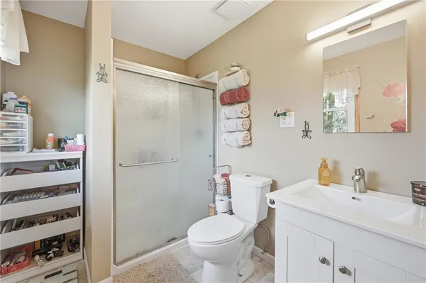 a bathroom with a sink toilet and shower