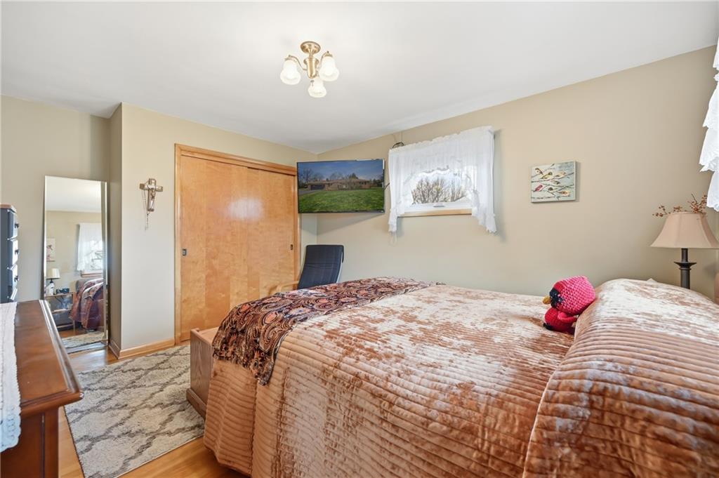 256 Donald Road Hermitage, PA 16148 - Photo 19 of 28 a bedroom with a bed and a chandelier