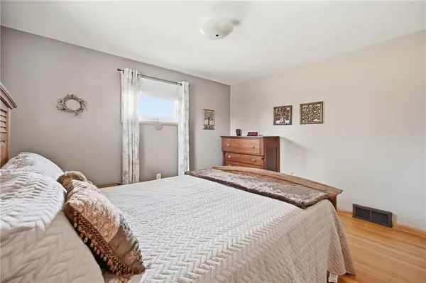 a bedroom with a bed and a painting