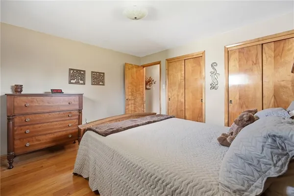a bedroom with a bed and a dresser
