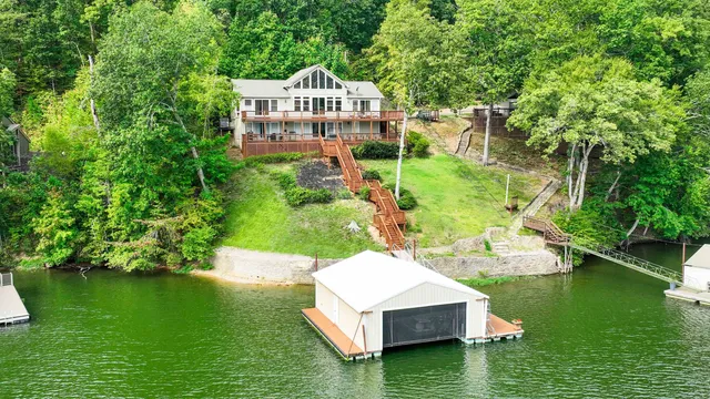 a view of a house with a yard and a pond