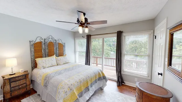 a bedroom with a large bed and a chandelier