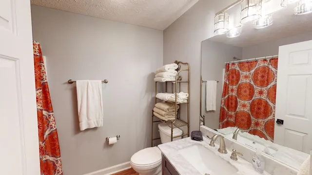 a bathroom with a sink toilet and shower
