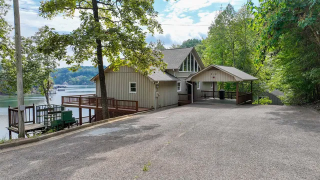 a view of a house with a yard and tree s