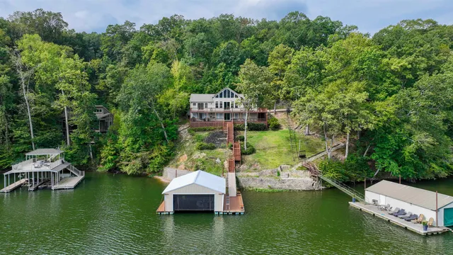 an aerial view of a house with a yard swimming pool and outdoor seating