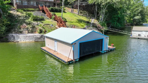a small pool with some trees in the background