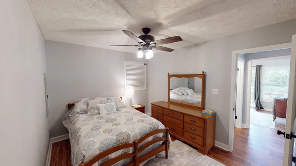 a bedroom with a bed and a chandelier