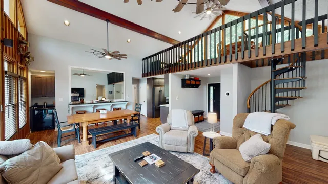 a living room with furniture fireplace and a chandelier