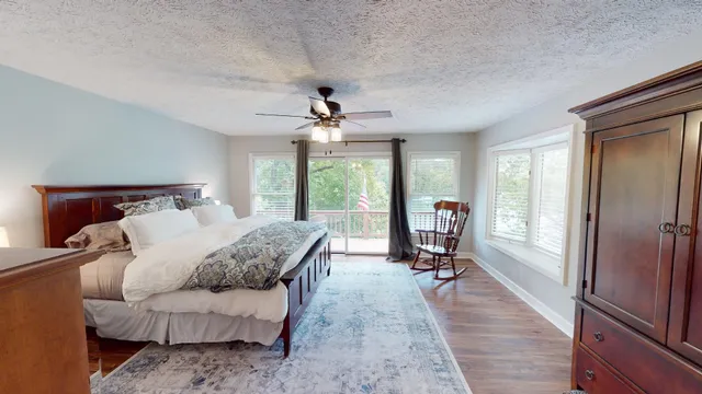 a living room with furniture gym equipment and a large window