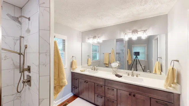 a bathroom with a double vanity sink mirror and double