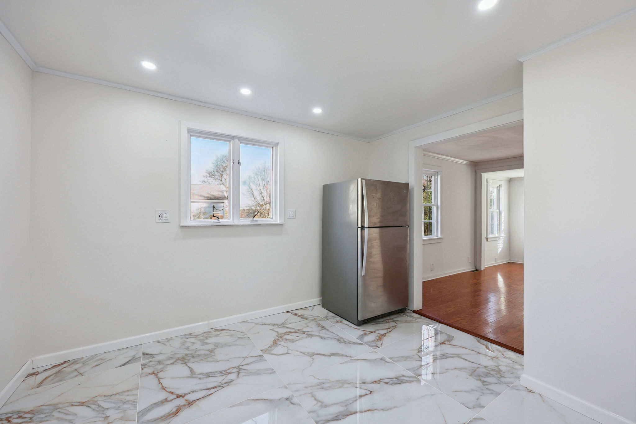 18 Lake Boulevard East Hampton, CT 06424 - Photo 9 of 31 a view of a refrigerator in kitchen and an empty room