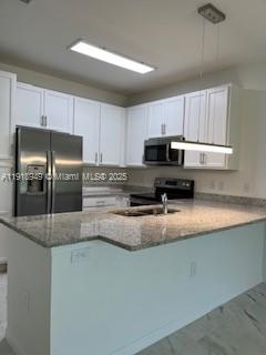 Davie Davie, FL 33314 - Photo 2 of 8 a kitchen with stainless steel appliances granite countertop a refrigerator a stove a sink a stove a microwave and a refrigerator