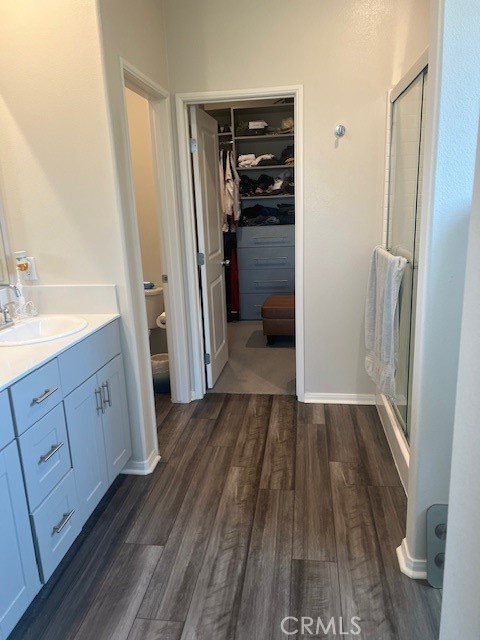 29901 Bridlegate Way Menifee, CA 92584 - Photo 15 of 43 a view of a walk in closet and wooden floor