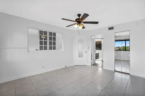 a view of a big yard with palm trees