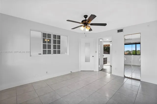 a view of a big yard with palm trees