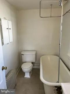 a bathroom with a toilet and a bathtub