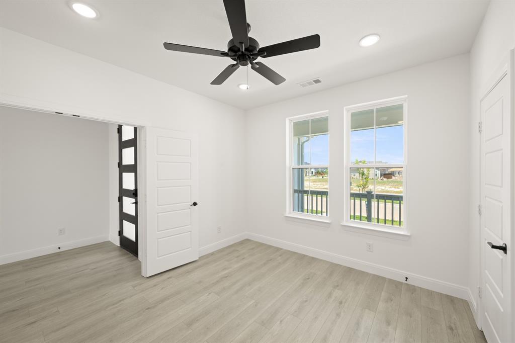 408 Dylan Way Midlothian, TX 76065 - Photo 14 of 40 a view of an empty room with a window and wooden floor