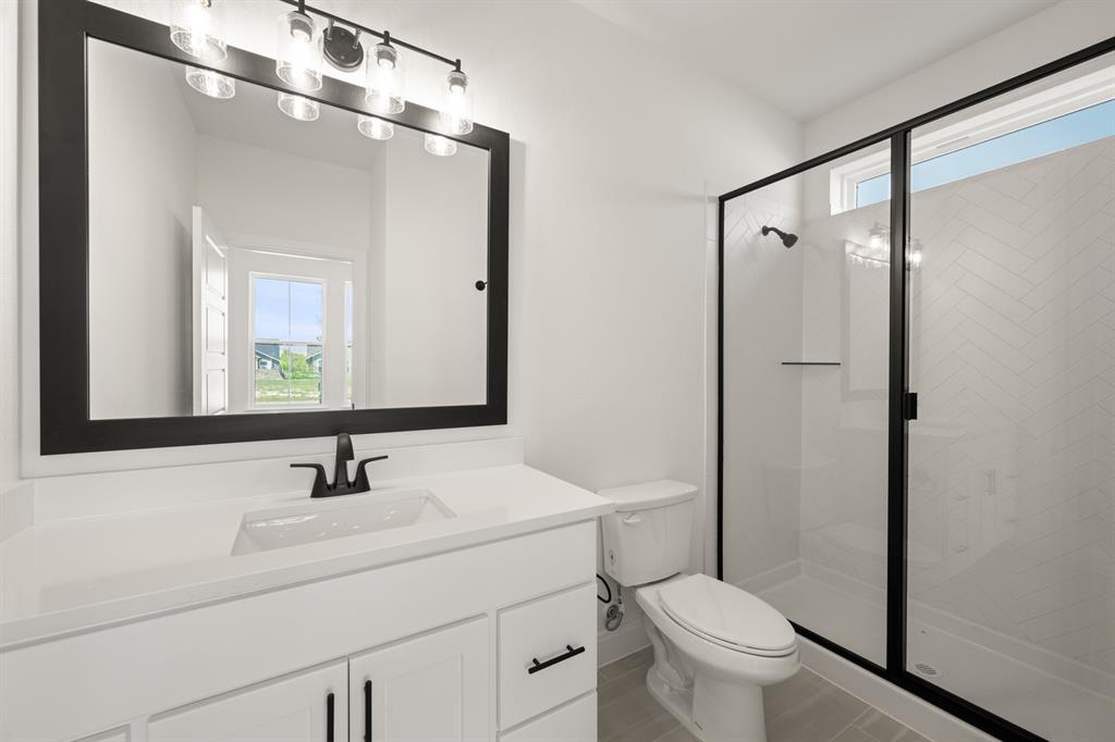 408 Dylan Way Midlothian, TX 76065 - Photo 17 of 40 a bathroom with a sink toilet and mirror