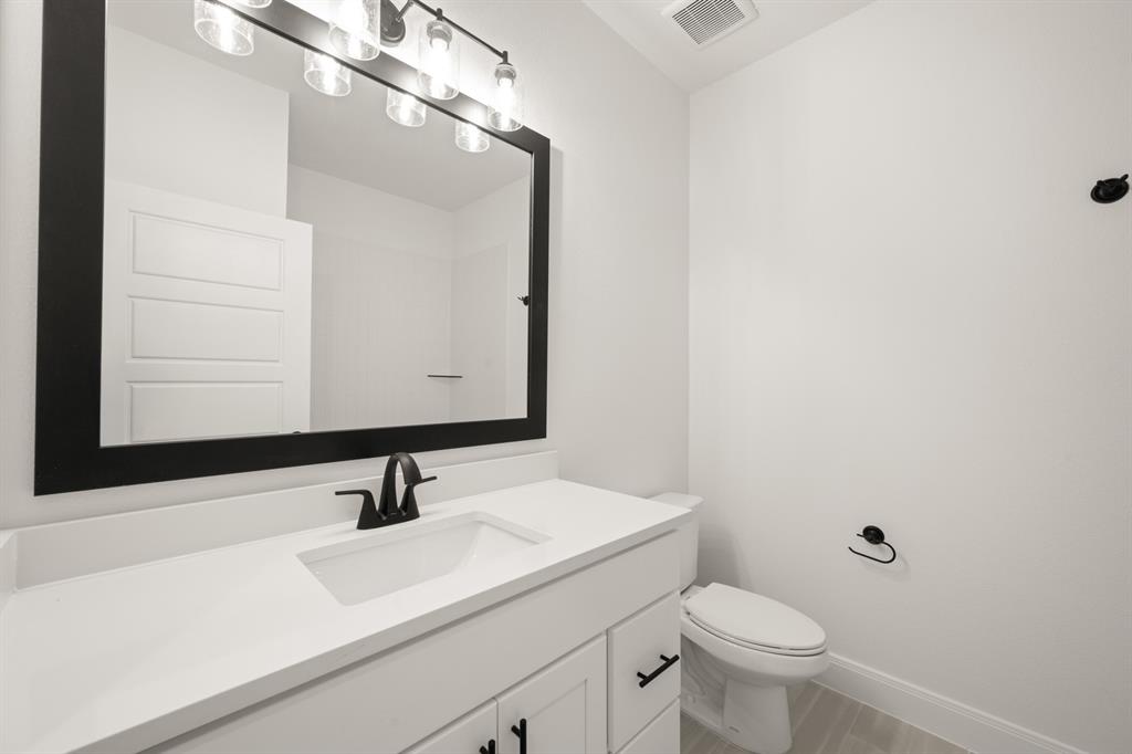 408 Dylan Way Midlothian, TX 76065 - Photo 20 of 40 a bathroom with a sink and a mirror