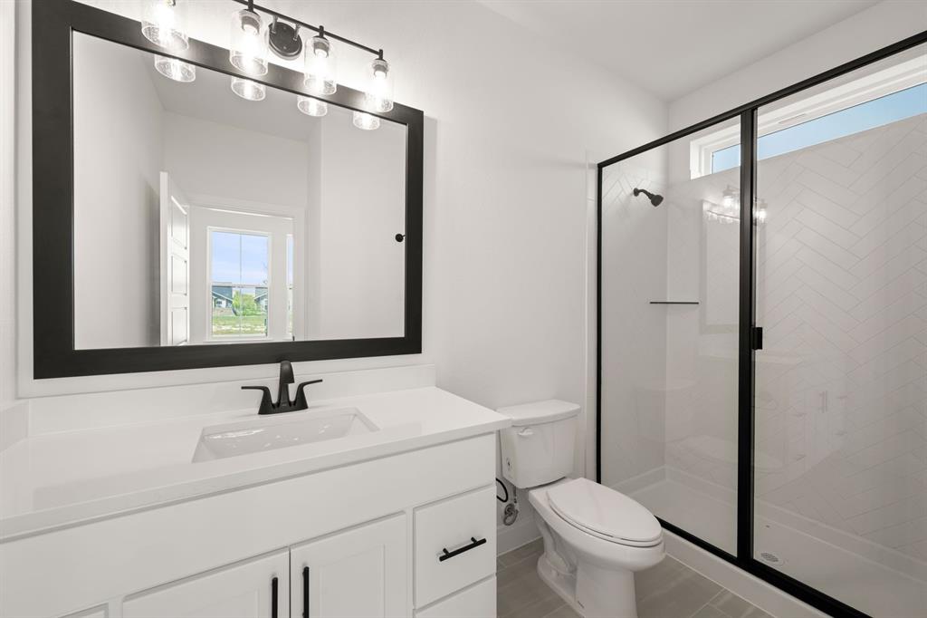 408 Dylan Way Midlothian, TX 76065 - Photo 22 of 40 a bathroom with a sink toilet and mirror