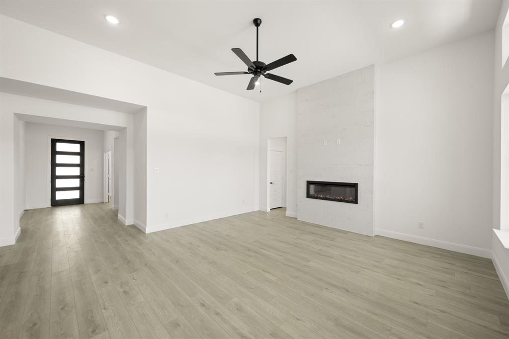 408 Dylan Way Midlothian, TX 76065 - Photo 23 of 40 a view of empty room with wooden floor and ceiling fan