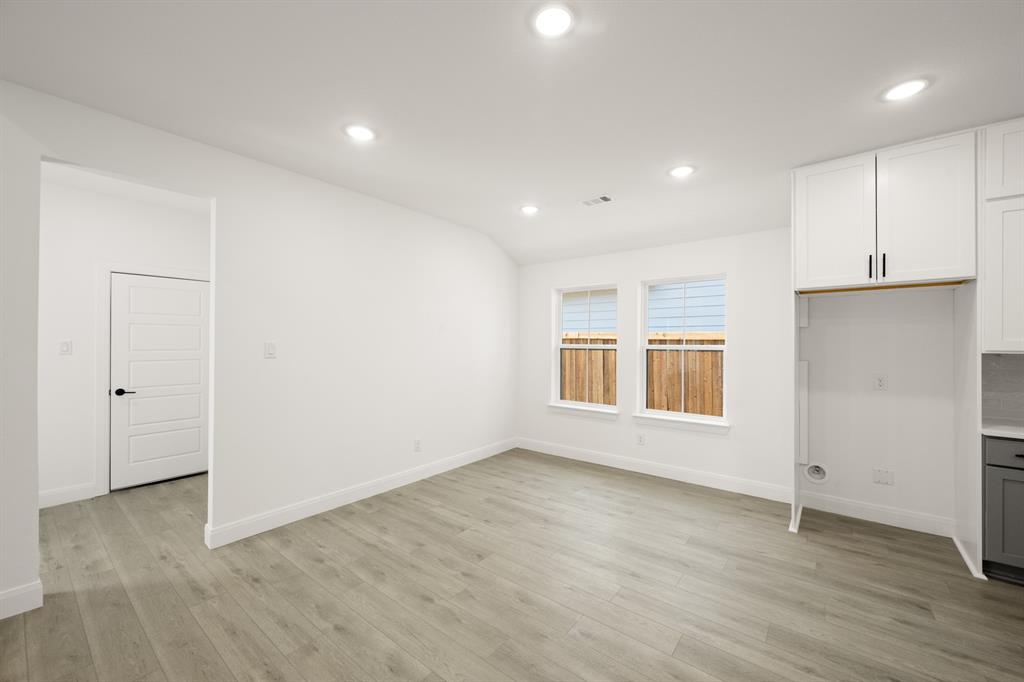 408 Dylan Way Midlothian, TX 76065 - Photo 26 of 40 an empty room with wooden floor and windows