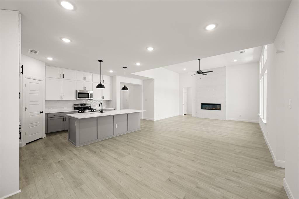 408 Dylan Way Midlothian, TX 76065 - Photo 27 of 40 a large kitchen with kitchen island a sink stainless steel appliances and cabinets