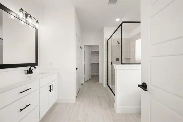 a bathroom with a double vanity sink mirror and