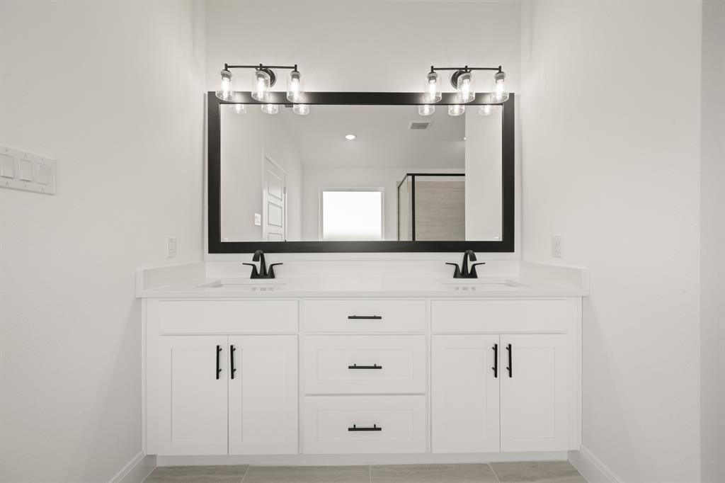 408 Dylan Way Midlothian, TX 76065 - Photo 38 of 40 a bathroom with a sink and a mirror