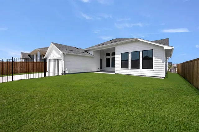 a view of a house next to a yard