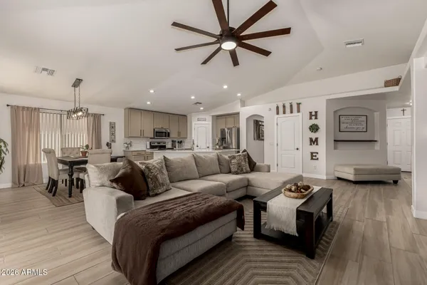 a living room with furniture and a wooden floor