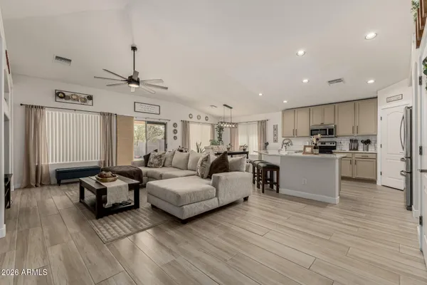 a living room with furniture and kitchen view