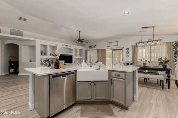 a kitchen with sink stove and cabinets