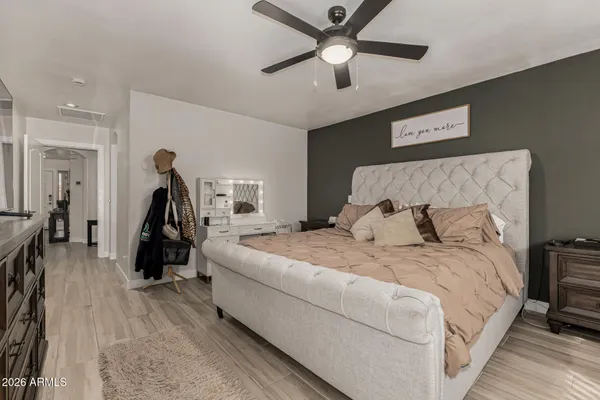 a bed room with a bed and a ceiling fan