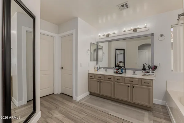 a spacious bathroom with a double vanity sink and a mirror