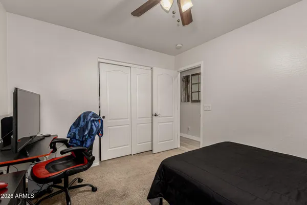 a bedroom with a bed and a chair