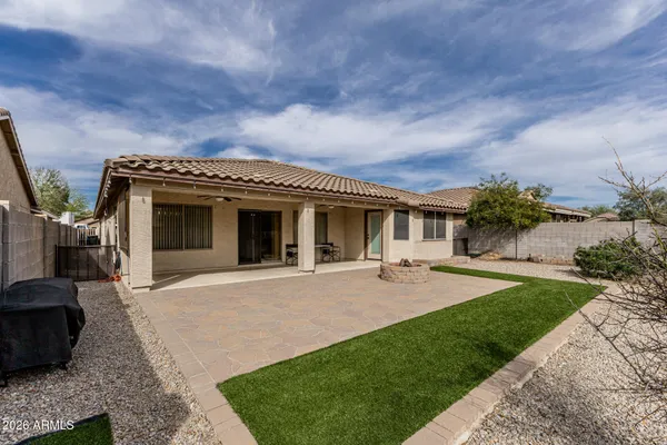 a front view of a house with a garden and patio