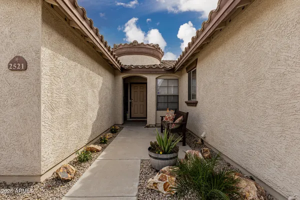 a front view of a house with outdoor seating and stairs