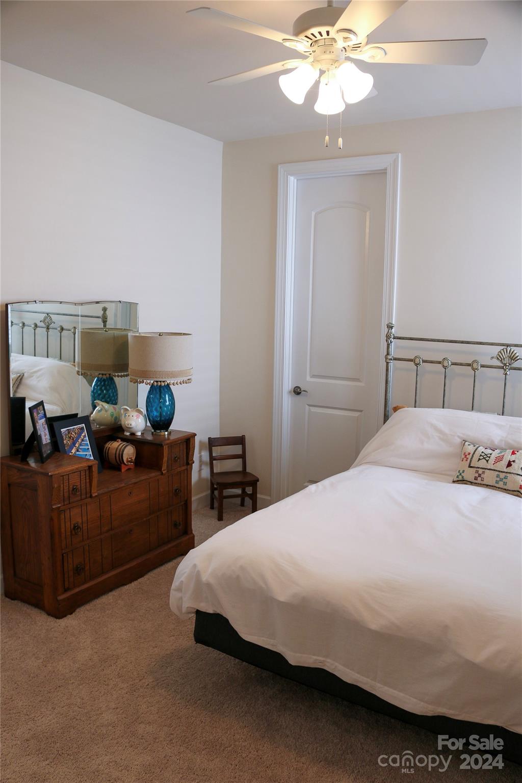 1296 Independence Street Tega Cay, SC 29708 - Photo 17 of 28 a bedroom with a bed and a chandelier