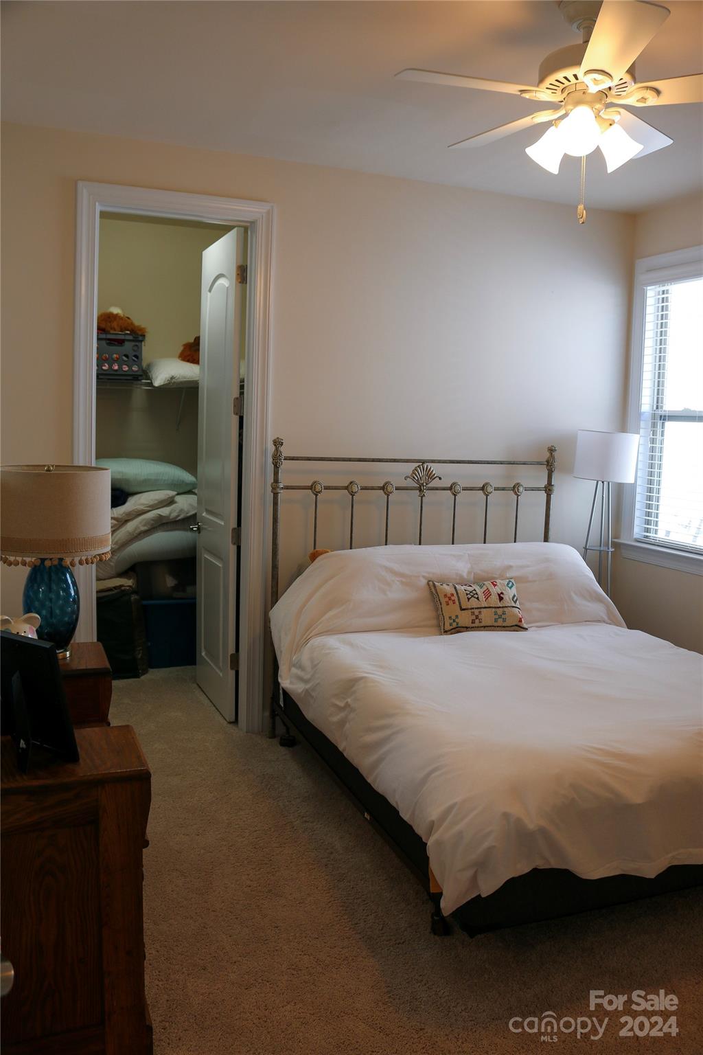 1296 Independence Street Tega Cay, SC 29708 - Photo 19 of 28 a bedroom with a bed and a chandelier