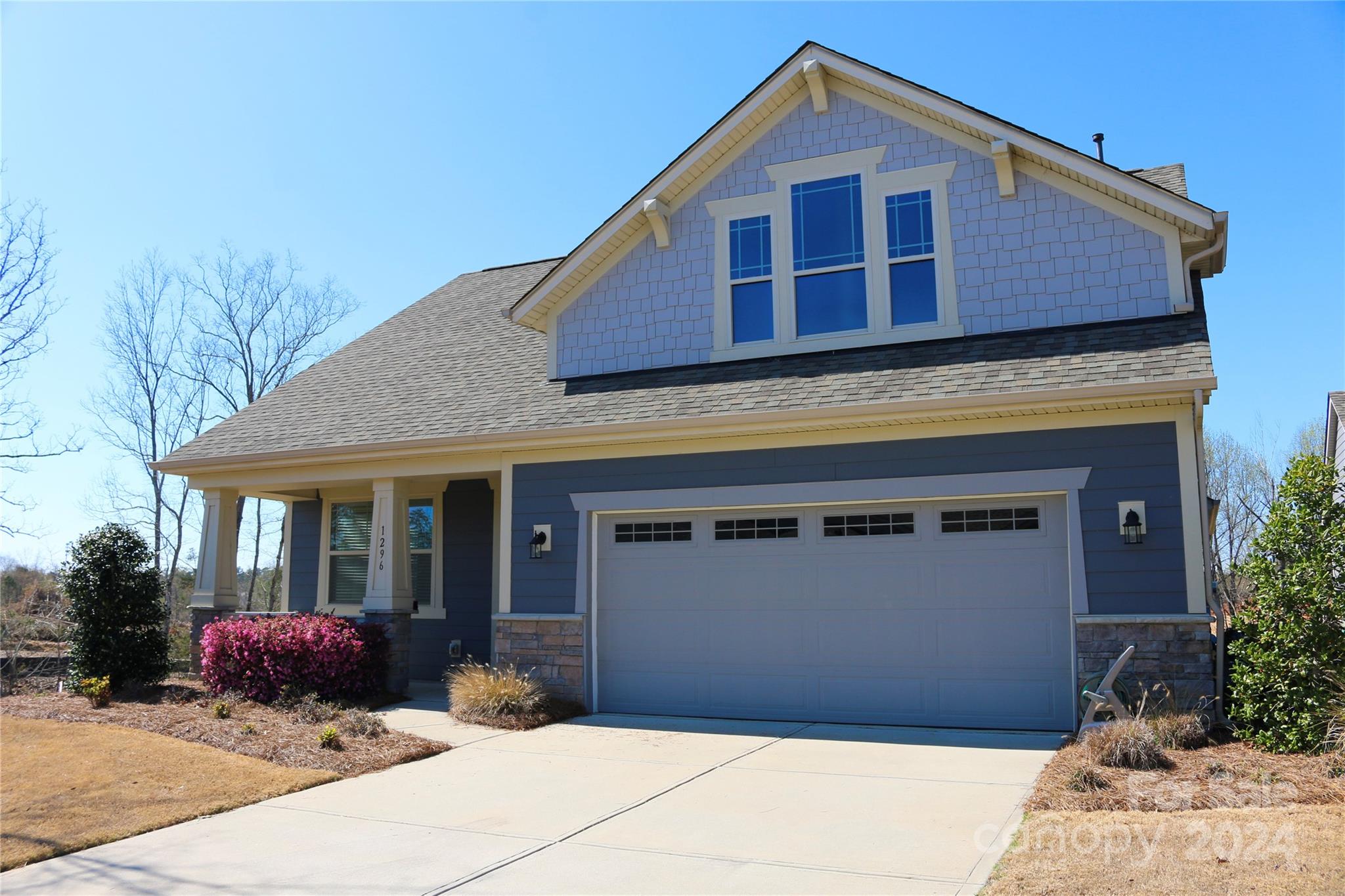 1296 Independence Street Tega Cay, SC 29708 - Photo 2 of 28 a front view of a house with a yard and garage