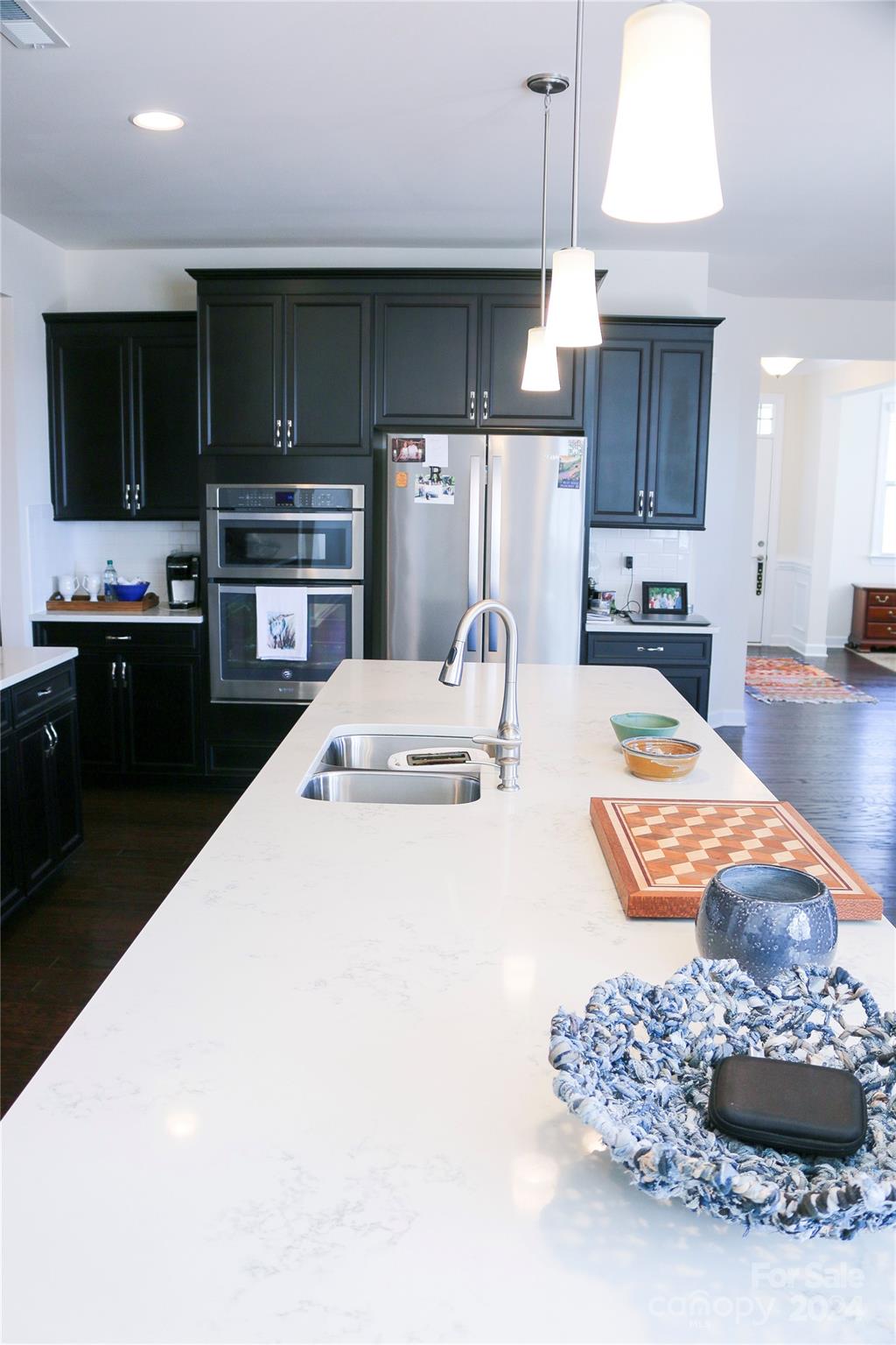 1296 Independence Street Tega Cay, SC 29708 - Photo 5 of 28 a kitchen with stainless steel appliances kitchen island granite countertop a sink a stove and a refrigerator