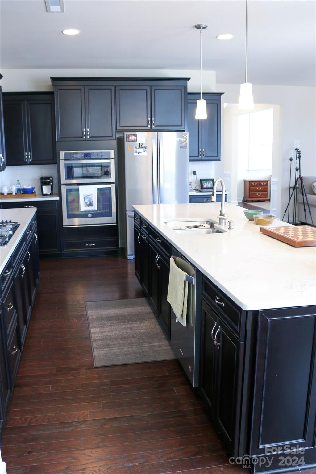 1296 Independence Street Tega Cay, SC 29708 - Photo 10 of 28 a kitchen with kitchen island granite countertop a sink stove and refrigerator