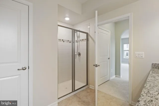 a bathroom with a glass shower door