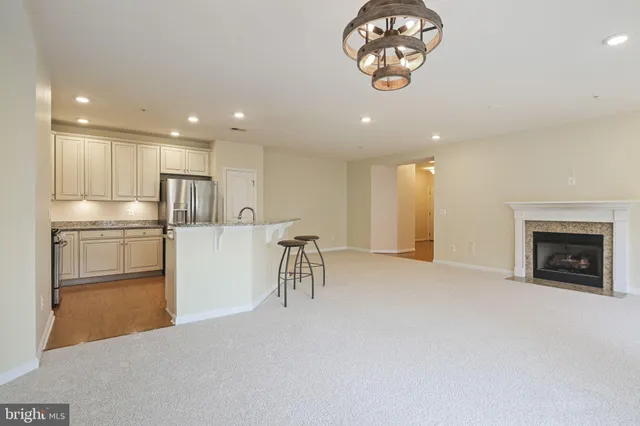 a view of a kitchen with a sink a refrigerator and a fireplace