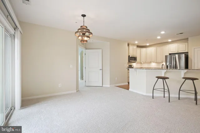 a view of a kitchen with a sink stainless steel appliances and cabinets