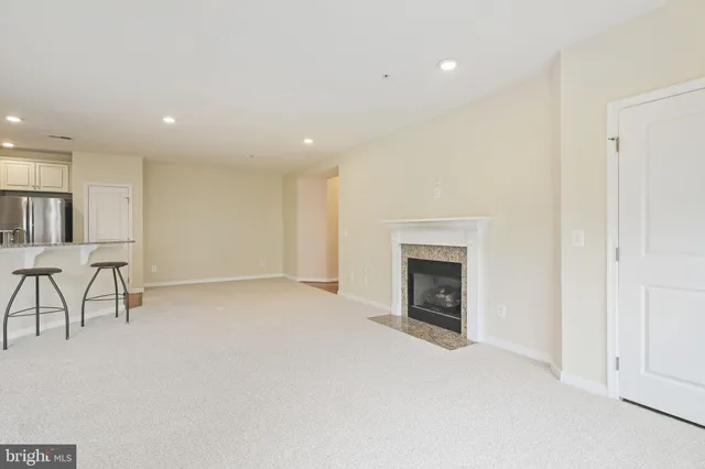 an empty room with furniture and a fireplace