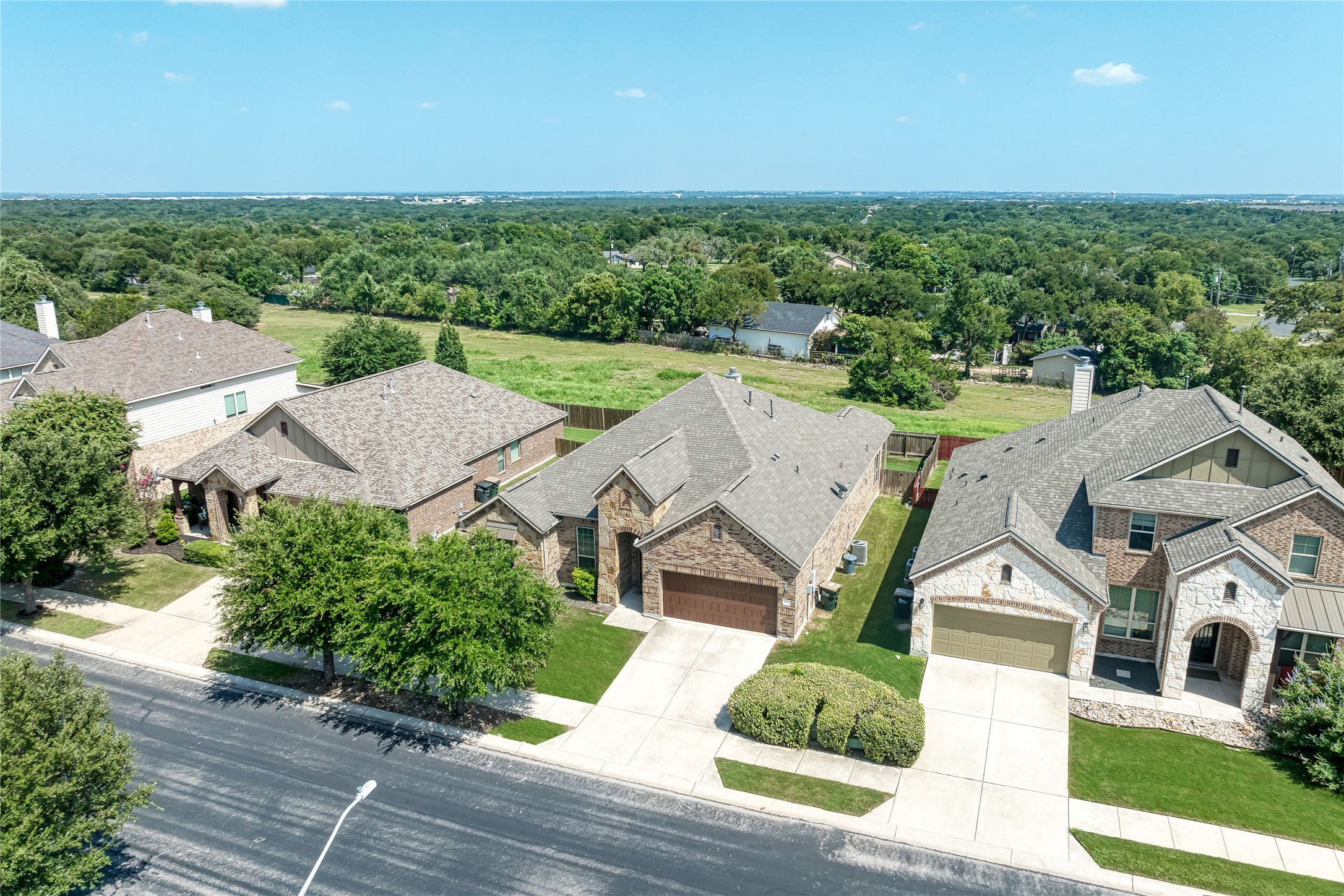 600 Rosedale Boulevard Georgetown, TX 78628 - Photo 3 of 28 An aerial perspective reveals well-maintained homes with neat lawns and ample green space beyond.
