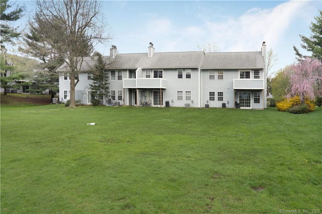 307 Spring Meadow Road, Unit 307 South Windsor, CT 06074 - Photo 1 of 1 a view of building with yard