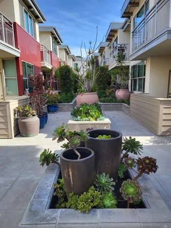 a view of a porch with dining table and chairs potted plants